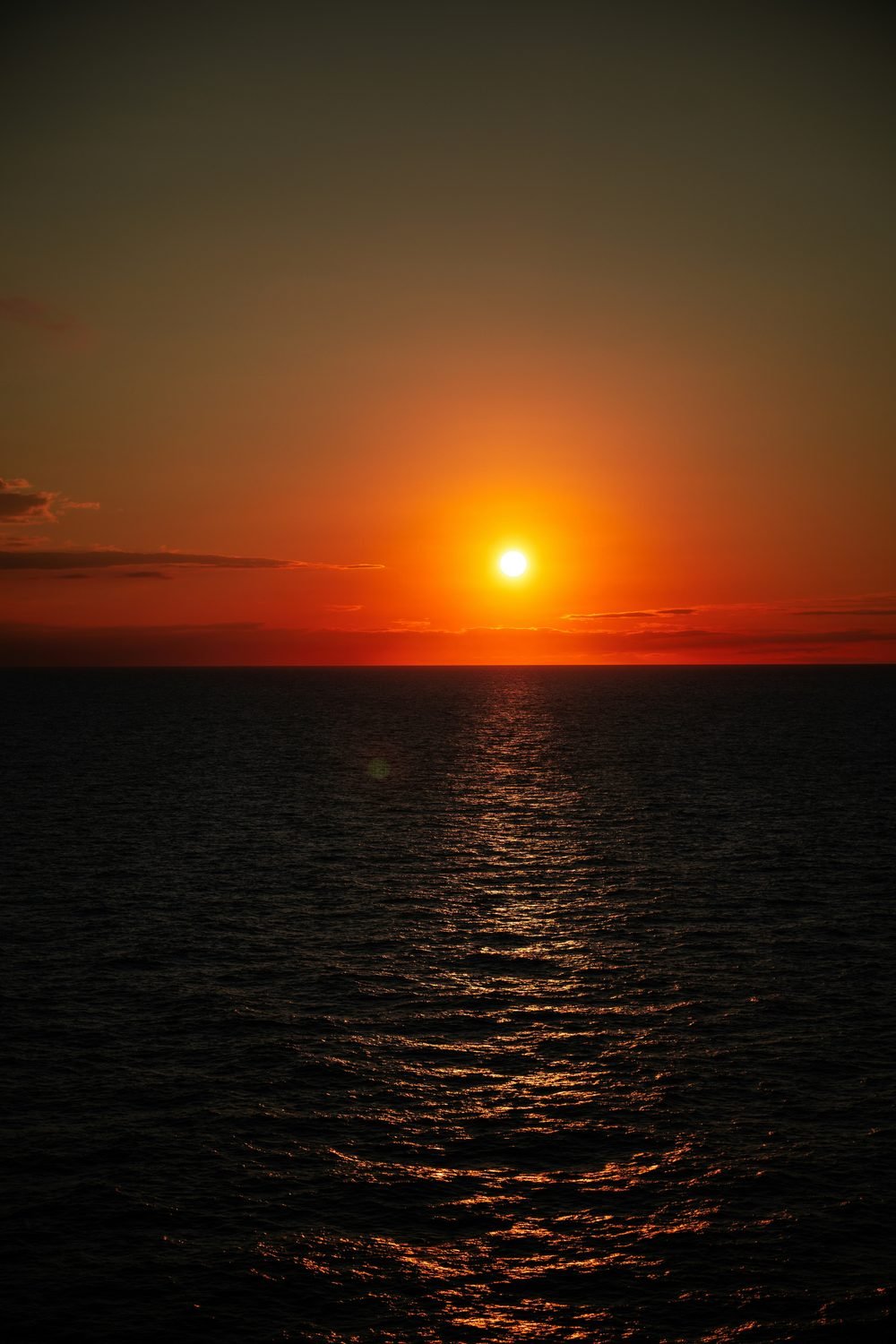 The sun setting over the sea — the horizon we all face